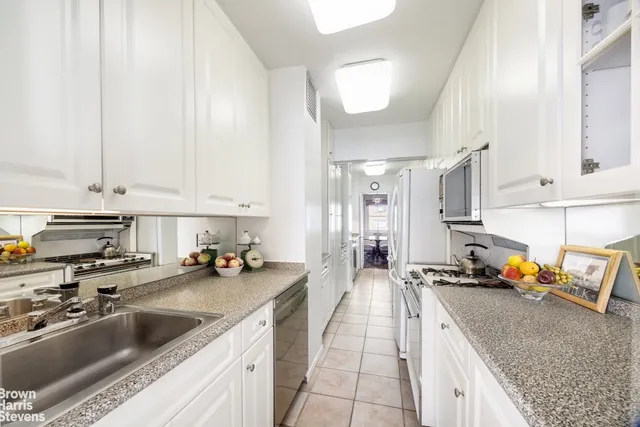 a dining room with furniture a chandelier and wooden floor