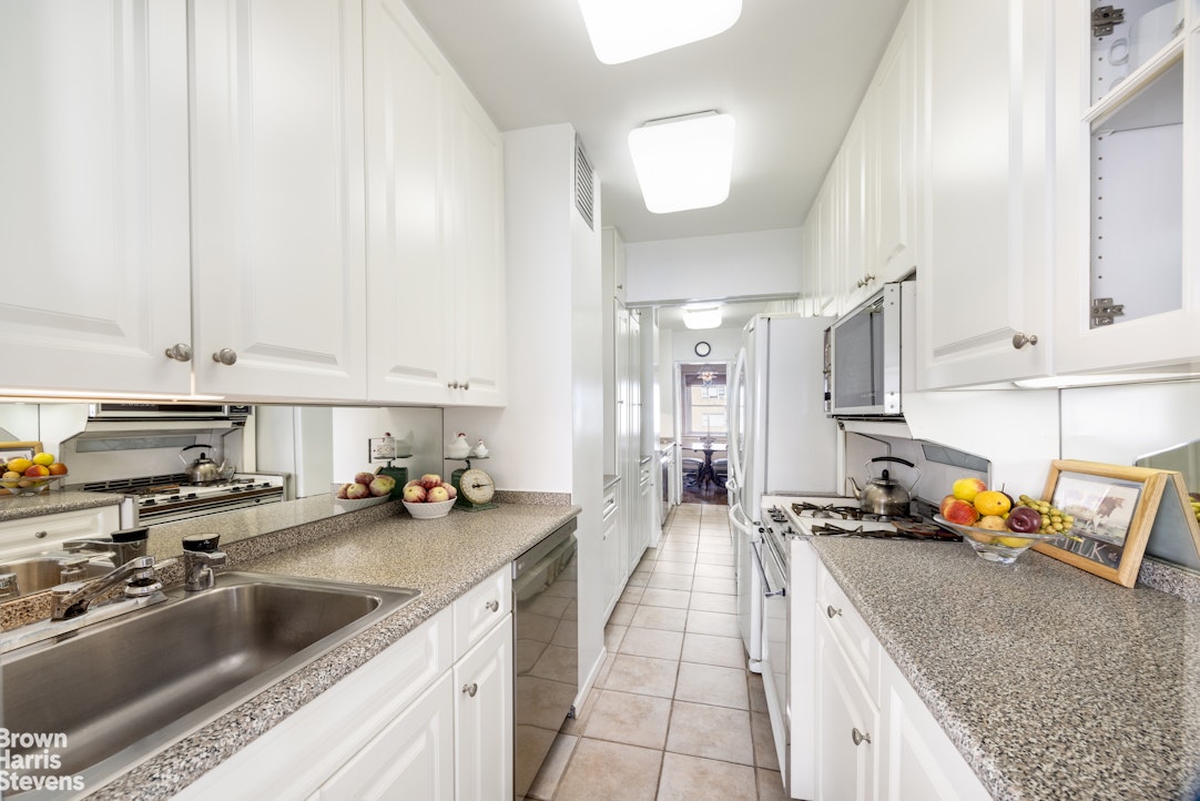 35 Park Avenue, Unit 12C Manhattan, NY 10016 - Photo 5 of 14 a kitchen with stainless steel appliances a sink a stove and a cabinets
