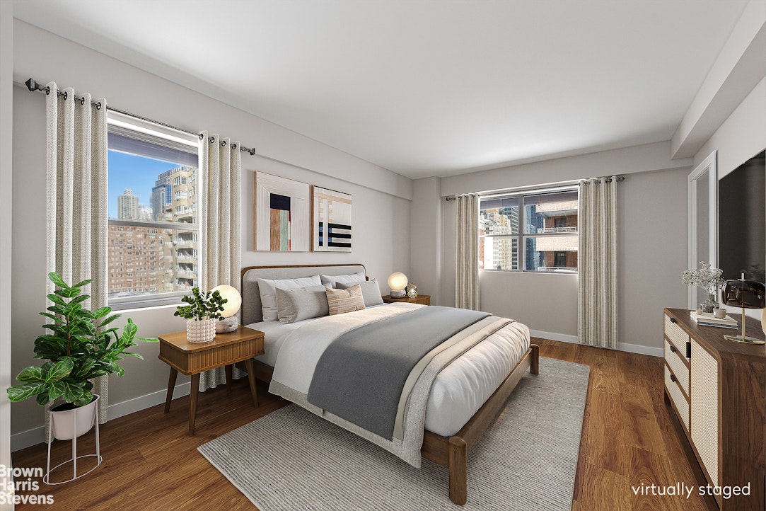 35 Park Avenue, Unit 12C Manhattan, NY 10016 - Photo 7 of 14 a bedroom with a bed table chair and a window
