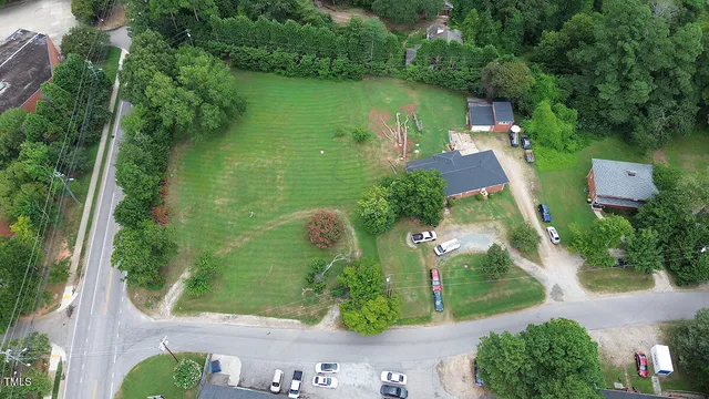 an aerial view of a house with a yard basket ball court and outdoor seating