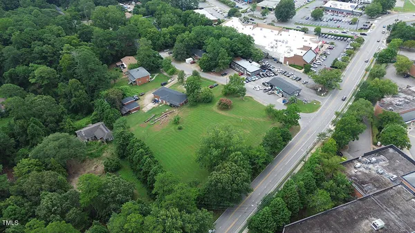 an aerial view of residential house with outdoor space and trees all around