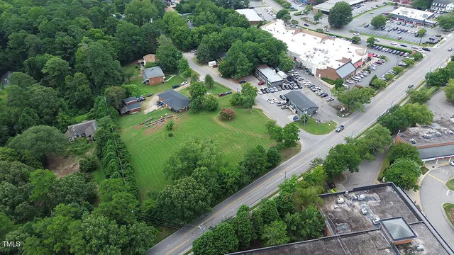 an aerial view of residential house with outdoor space and trees all around