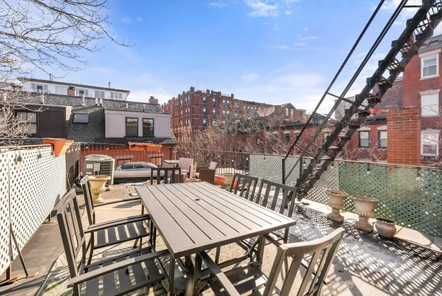 a view of a patio with table and chairs and potted plants