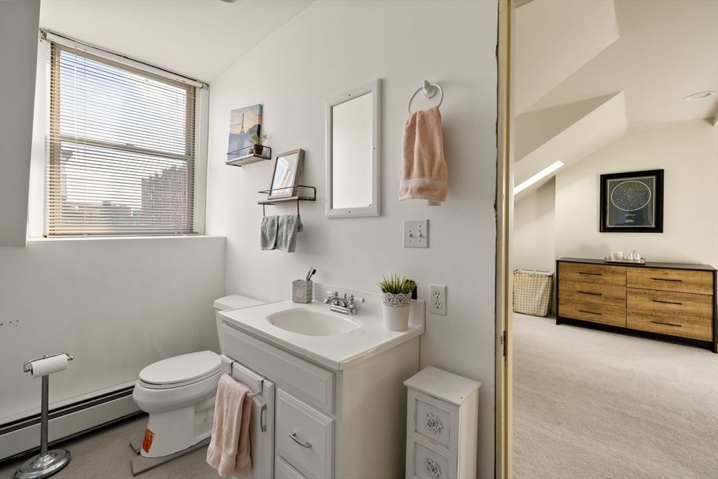 468 Shawmut Avenue, Unit 2 Boston, MA 02118 - Photo 17 of 30 a bathroom with a toilet sink and mirror