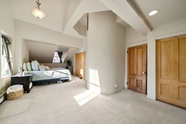 a bedroom with furniture and a window