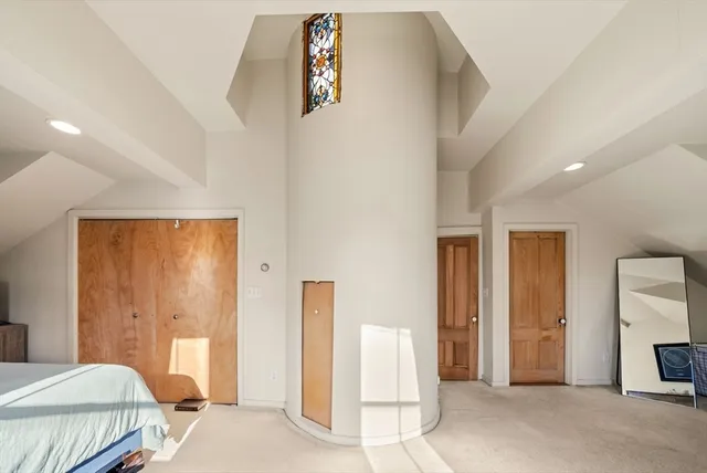 a bedroom with a bed and a painting on the wall