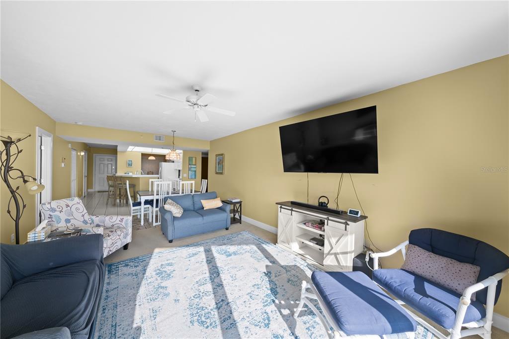 4575 South Atlantic Avenue, Unit 6209 Ponce Inlet, FL 32127 - Photo 11 of 53 a living room with furniture and a flat screen tv