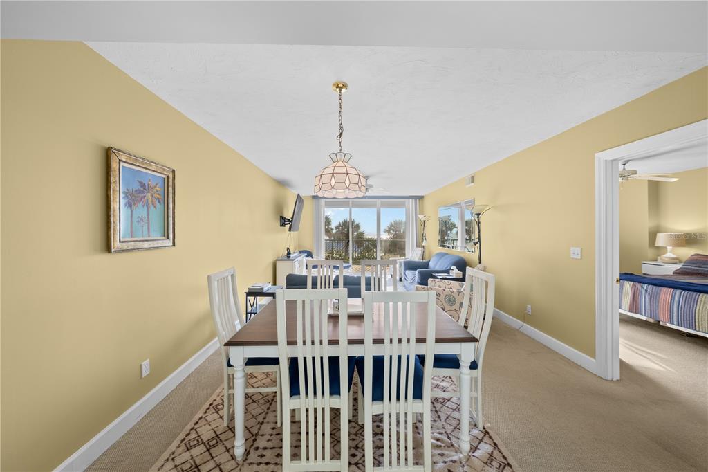 4575 South Atlantic Avenue, Unit 6209 Ponce Inlet, FL 32127 - Photo 13 of 53 a view of a dining room with furniture window and wooden floor