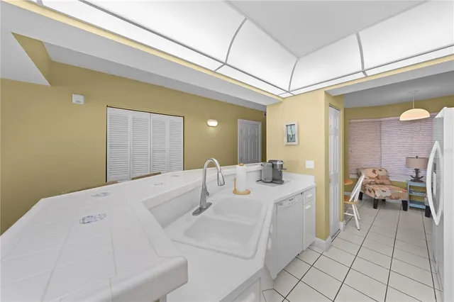 a kitchen with a refrigerator and white cabinets