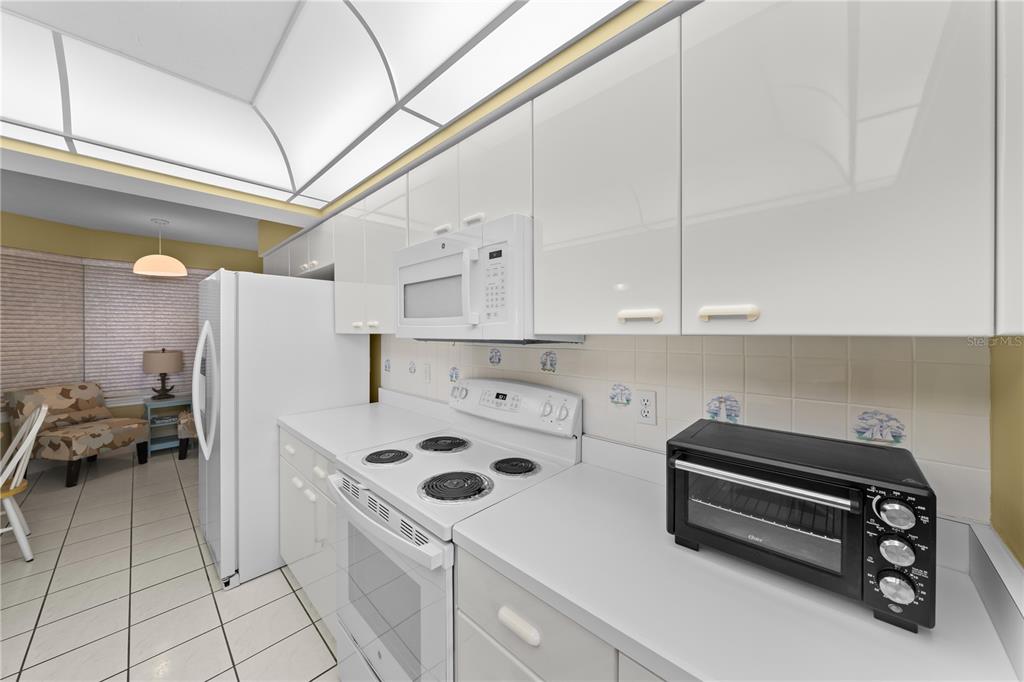 4575 South Atlantic Avenue, Unit 6209 Ponce Inlet, FL 32127 - Photo 16 of 53 a kitchen with a refrigerator and white cabinets