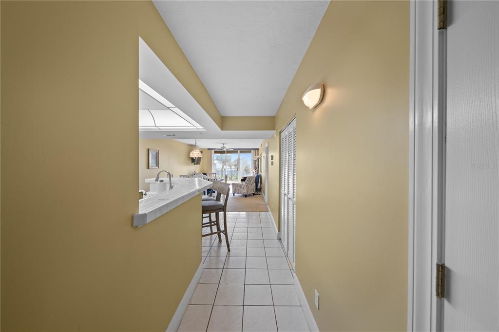 4575 South Atlantic Avenue, Unit 6209 Ponce Inlet, FL 32127 - Photo 21 of 53 a view of a hallway with a dining table & chairs