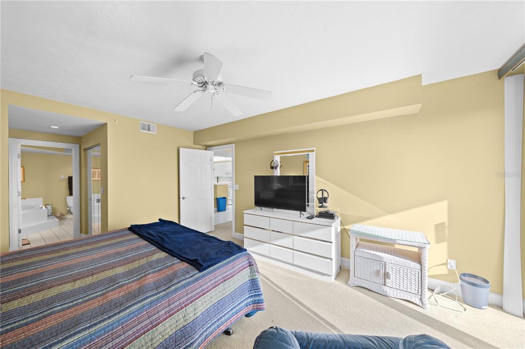 4575 South Atlantic Avenue, Unit 6209 Ponce Inlet, FL 32127 - Photo 27 of 53 a bedroom with a bed and a flat screen tv