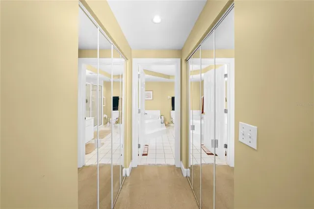 a spacious bathroom with a tub sink and mirror