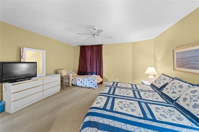 a bedroom with furniture and a flat screen tv