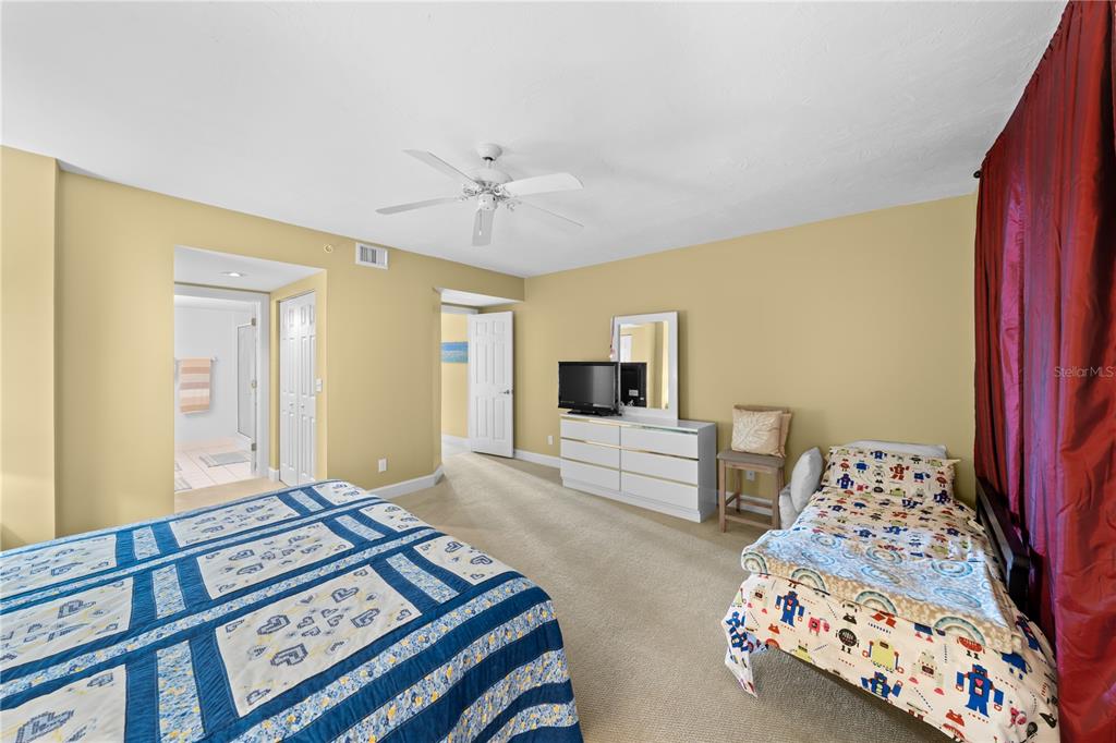 4575 South Atlantic Avenue, Unit 6209 Ponce Inlet, FL 32127 - Photo 34 of 53 a bedroom with furniture and a flat screen tv