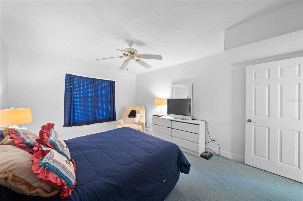 4575 South Atlantic Avenue, Unit 6209 Ponce Inlet, FL 32127 - Photo 43 of 53 a bedroom with a bed and a chandelier