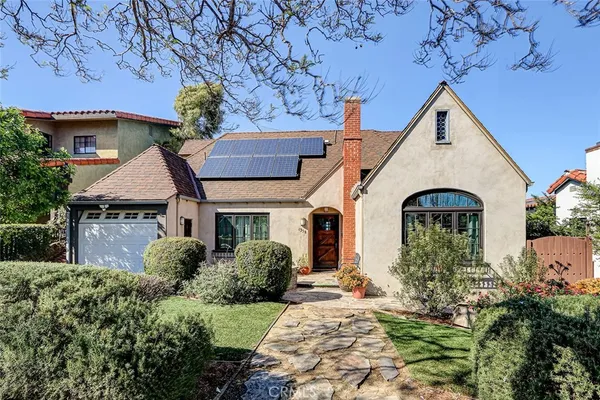 a front view of a house with garden