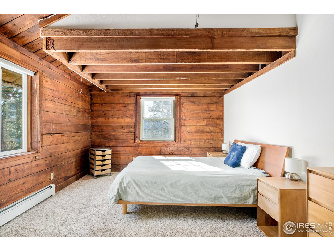 3714 Ridge Road Nederland, CO 80466 - Photo 15 of 38 a bedroom with a bed and wooden floor