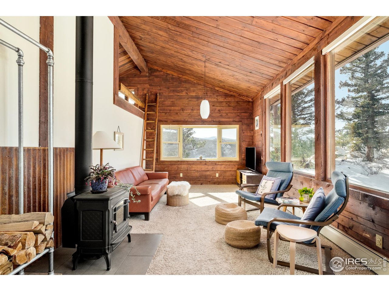 3714 Ridge Road Nederland, CO 80466 - Photo 3 of 38 a living room with furniture and large windows