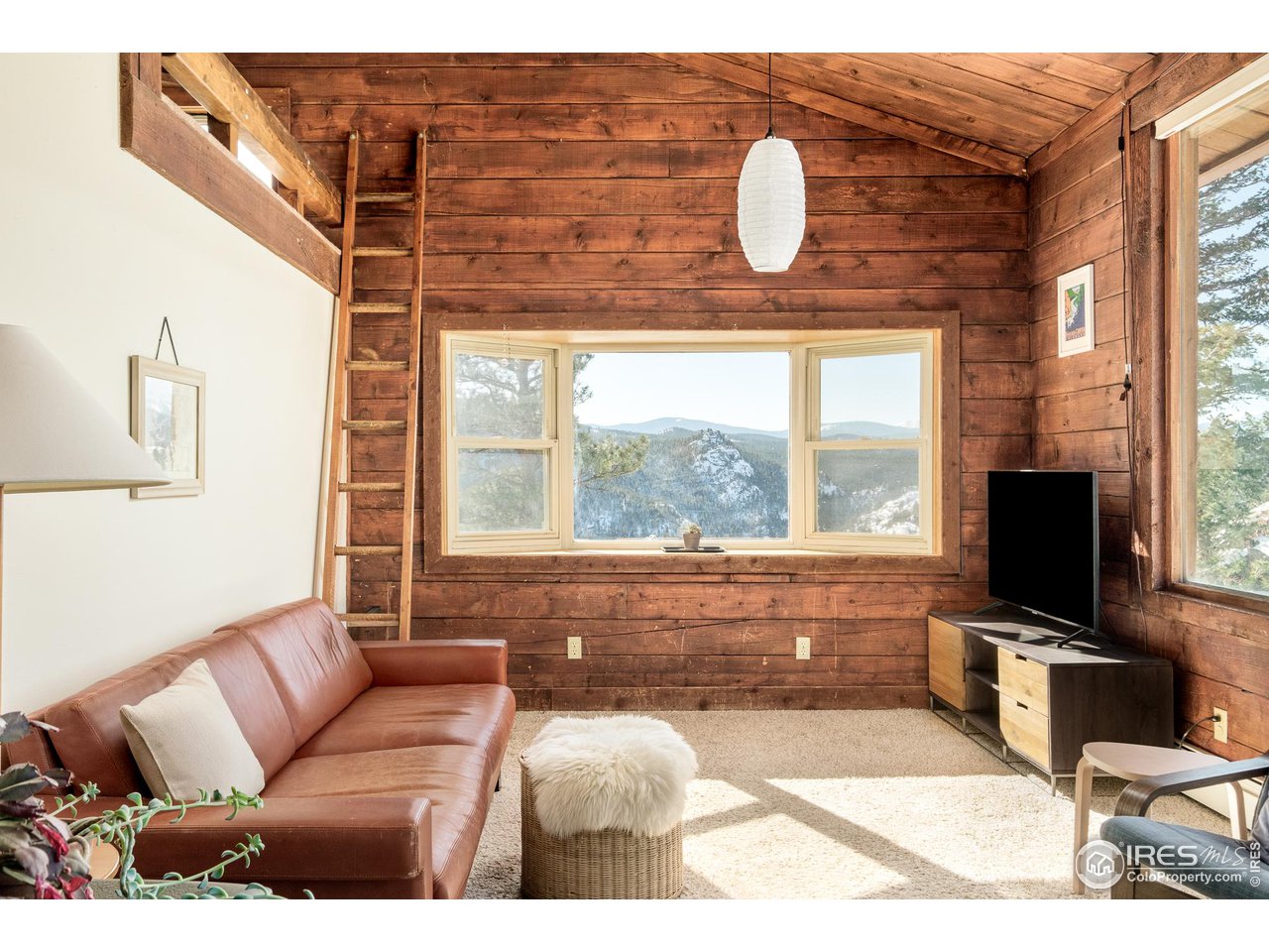 3714 Ridge Road Nederland, CO 80466 - Photo 5 of 38 a living room with furniture a flat screen tv and a large window