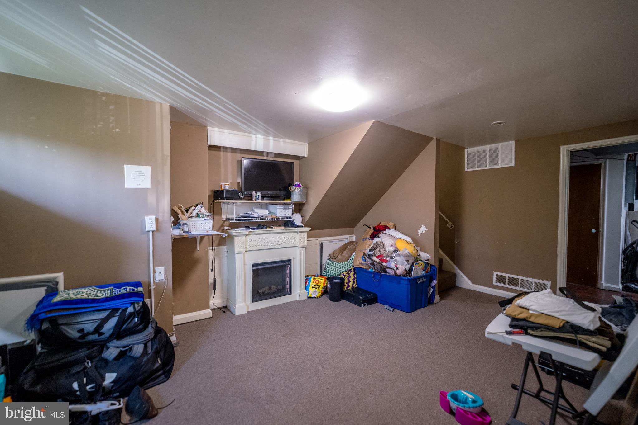 4125 Ronis Road Pikesville, MD 21208 - Photo 26 of 40 a living room with furniture and a fireplace