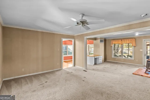 a view of a livingroom with furniture and staircase