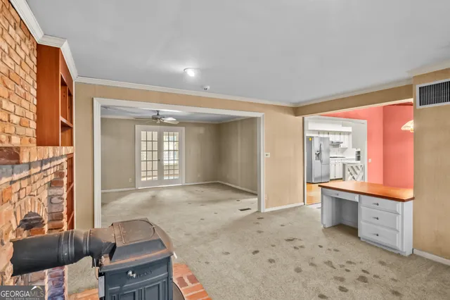 a view of a room with table and chairs