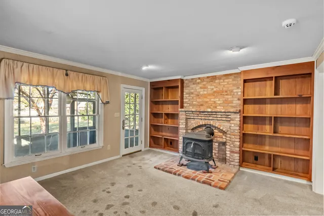 a view of a kitchen with refrigerator and wooden floor