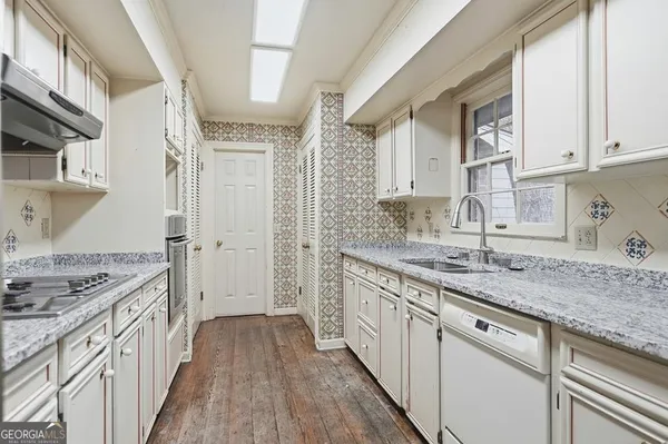 a livingroom with workspace a couch and a window