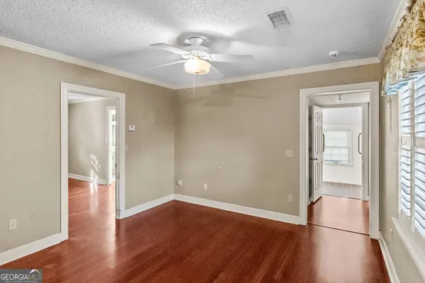 wooden floor in an empty room with a window