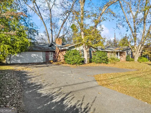 a backyard of a building with large trees
