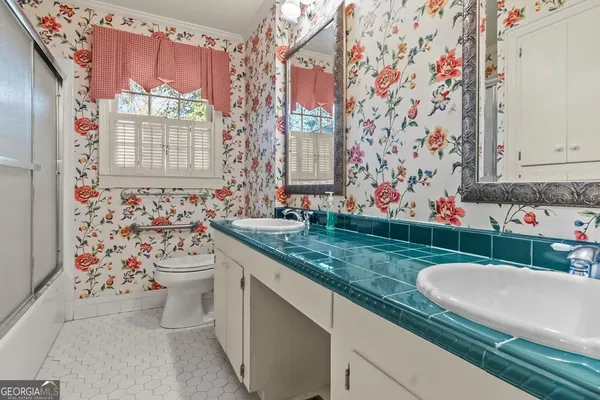 a bathroom with a sink vanity and a mirror