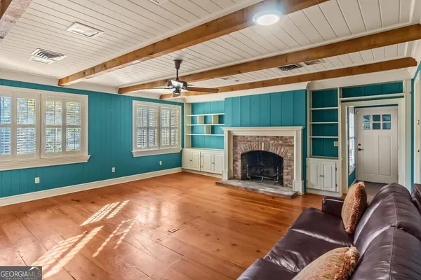 a kitchen with a sink and large windows