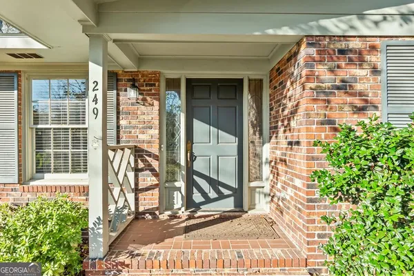 a view of a room with wooden floor chandelier and windows