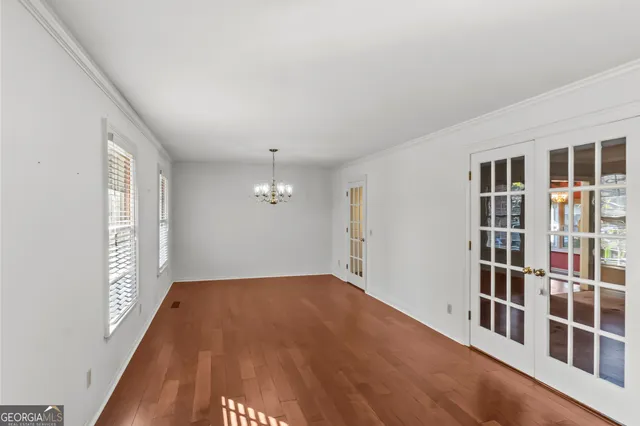 an empty room with a empty space and windows