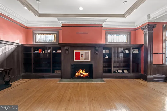 an empty room with a fireplace and window