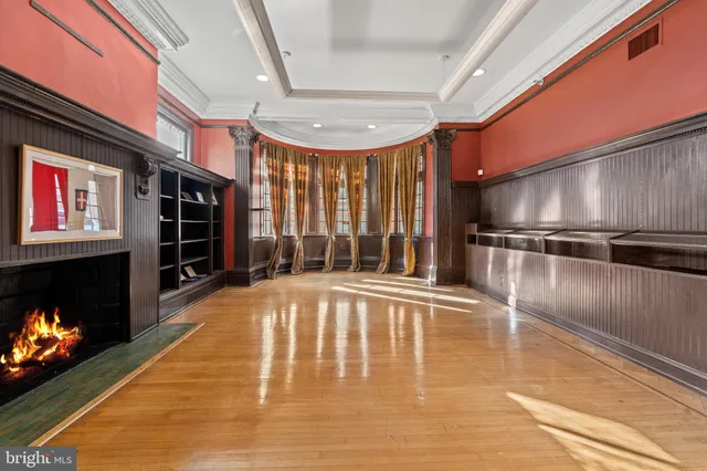 a view of an empty room with a fireplace and a window