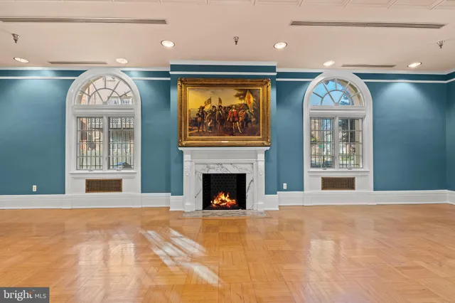 a view of an entryway with a fireplace and a chandelier