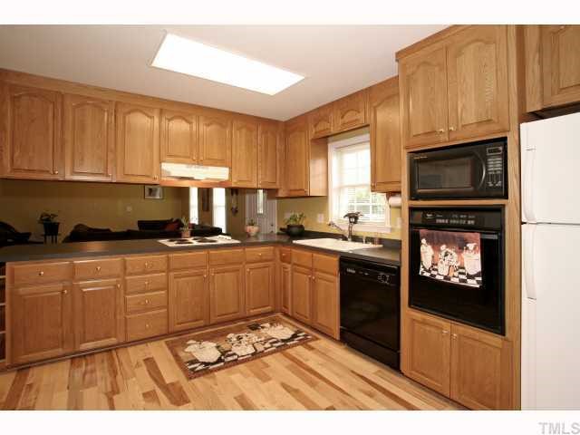 302 Graham Pond Road Angier, NC 27501 - Photo 5 of 12 a kitchen with stainless steel appliances granite countertop a refrigerator stove top oven and sink