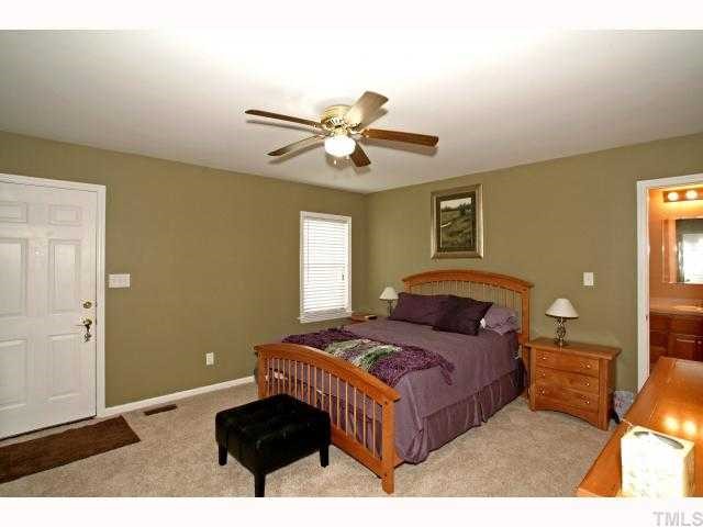 302 Graham Pond Road Angier, NC 27501 - Photo 7 of 12 a bedroom with a bed and window
