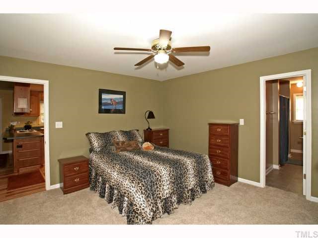 302 Graham Pond Road Angier, NC 27501 - Photo 8 of 12 a bedroom with a bed and a chandelier