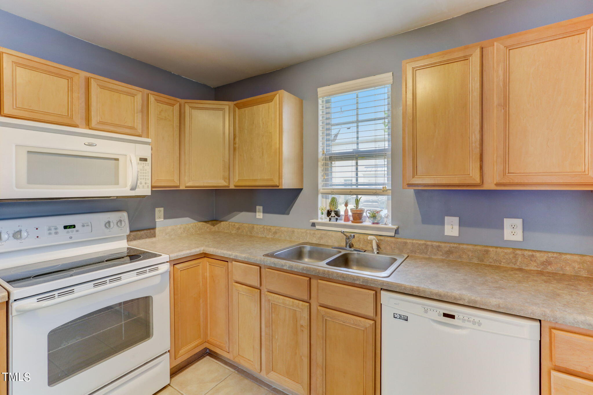 9802 Grettle Court Raleigh, NC 27617 - Photo 11 of 22 a kitchen with a sink stove and cabinets