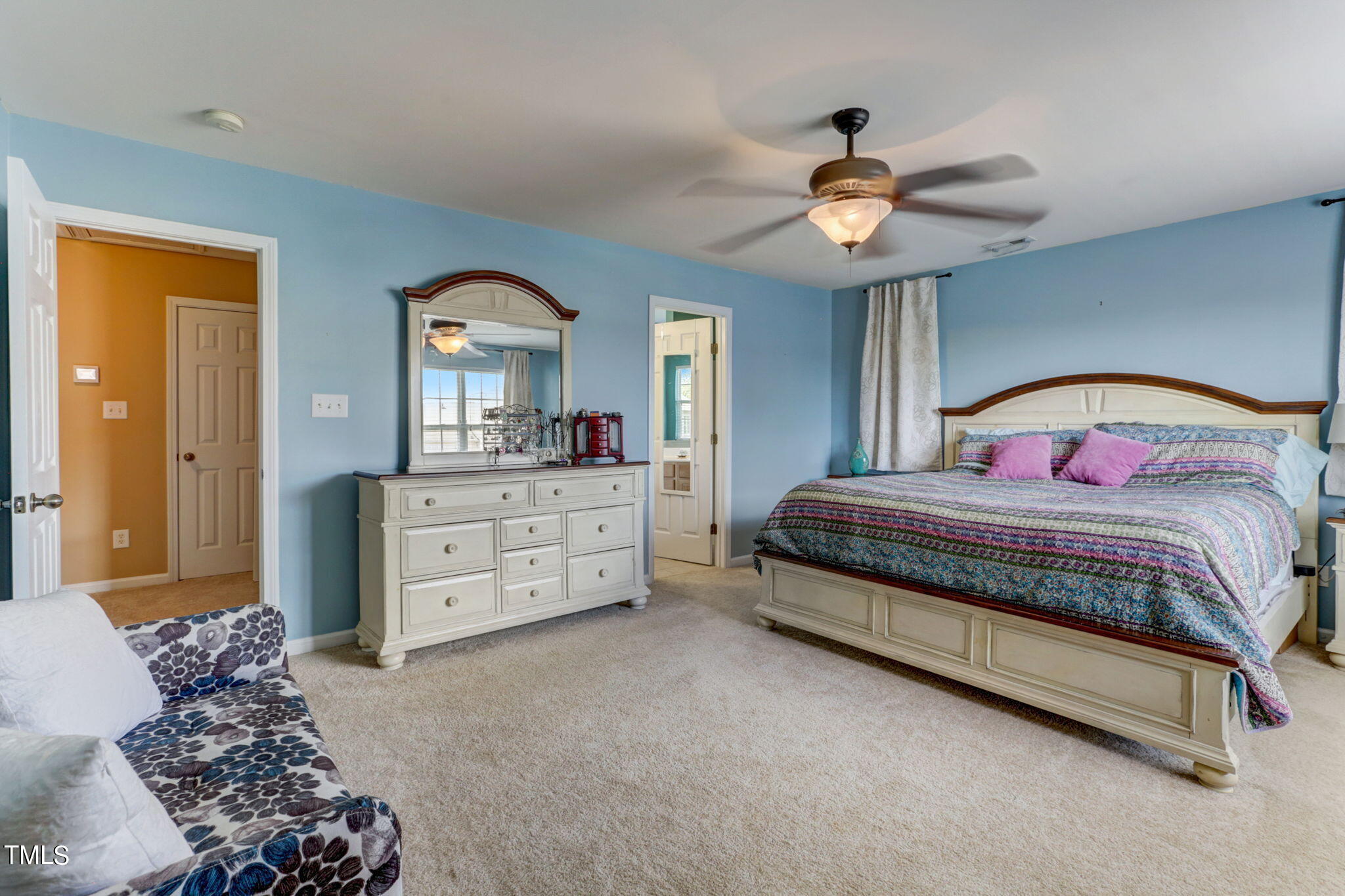 9802 Grettle Court Raleigh, NC 27617 - Photo 13 of 22 a bedroom with a bed and a chandelier