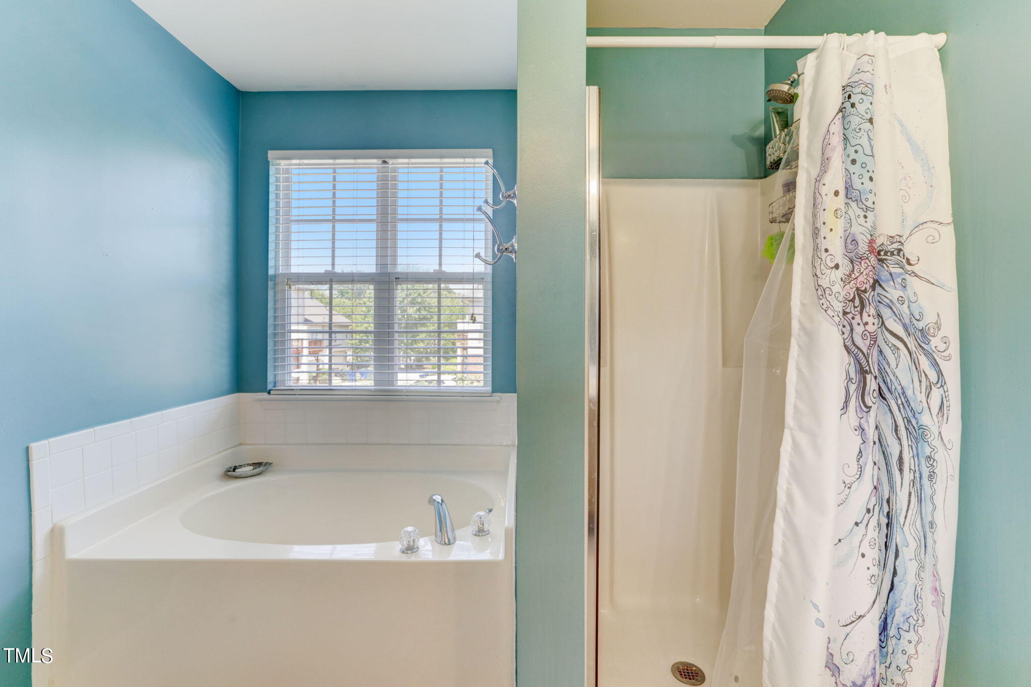 9802 Grettle Court Raleigh, NC 27617 - Photo 15 of 22 a white bath tub sitting next to a window