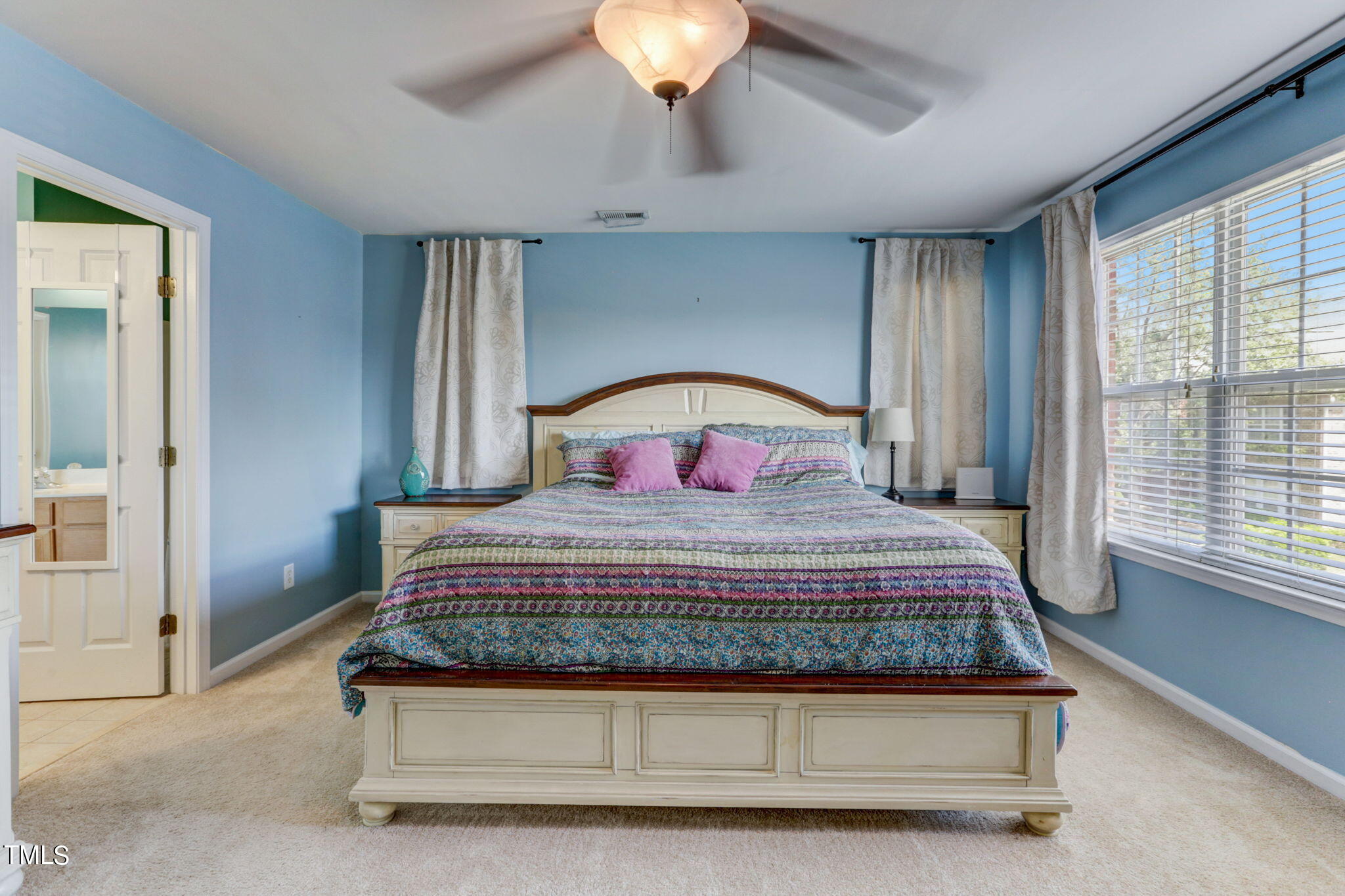 9802 Grettle Court Raleigh, NC 27617 - Photo 16 of 22 a bedroom with a bed and a chandelier