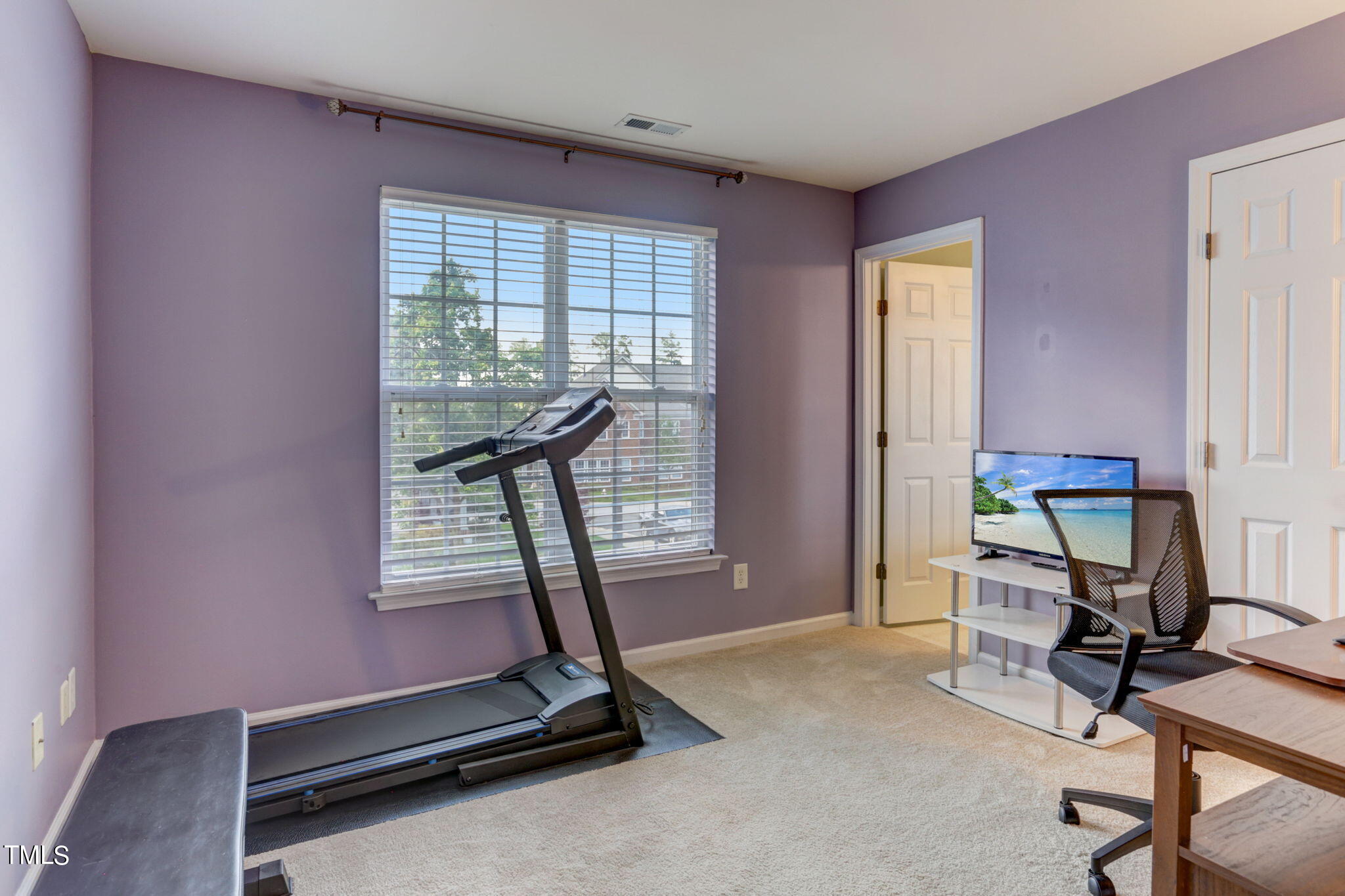 9802 Grettle Court Raleigh, NC 27617 - Photo 18 of 22 a room with gym equipment and a window