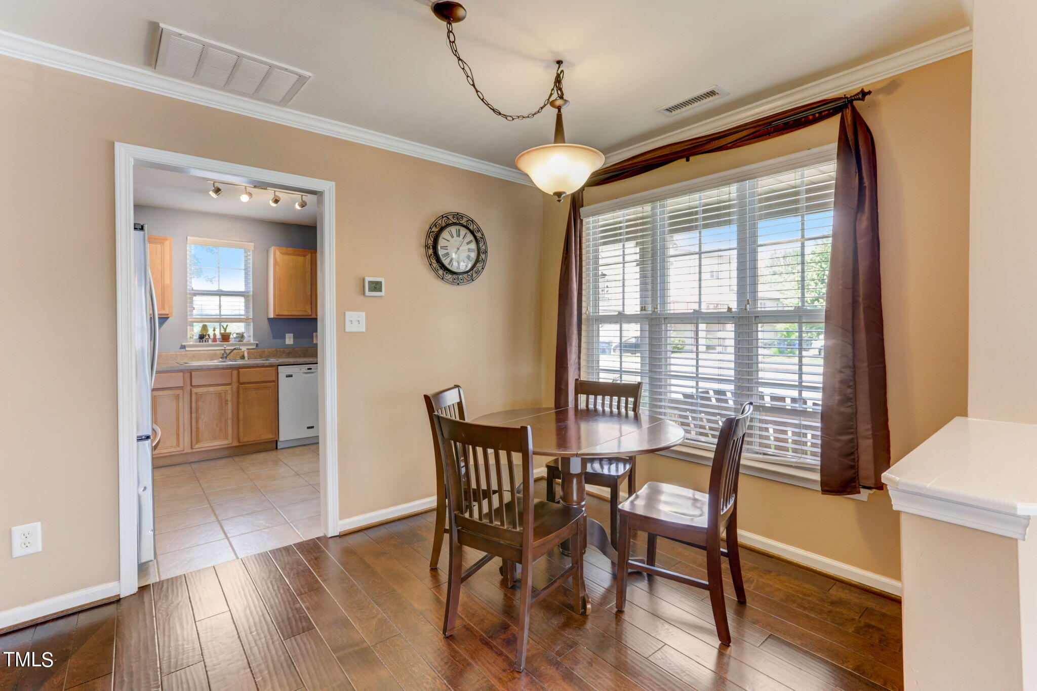 9802 Grettle Court Raleigh, NC 27617 - Photo 9 of 22 a view of a dining room with furniture window and wooden floor