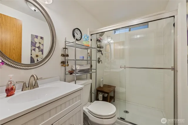 a bathroom with a sink mirror vanity and toilet