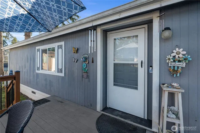 a view of a hallway with wooden floor and a dining room