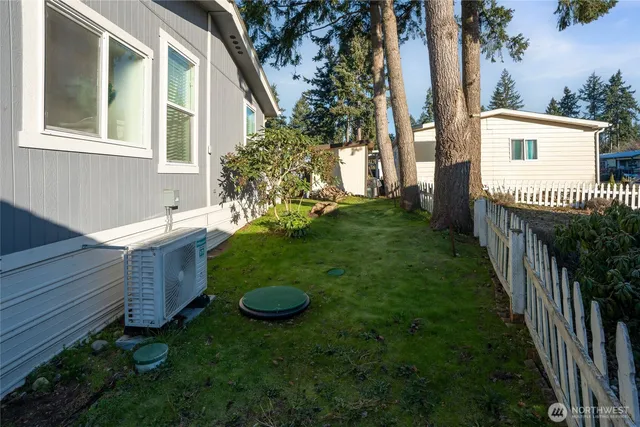 a view of a house with a backyard and porch